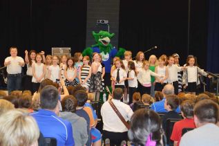 GREC's gryphon mascot joins the school’s primary/junior choir for a rousing school cheer that ended the new school official dedication ceremony on May 22